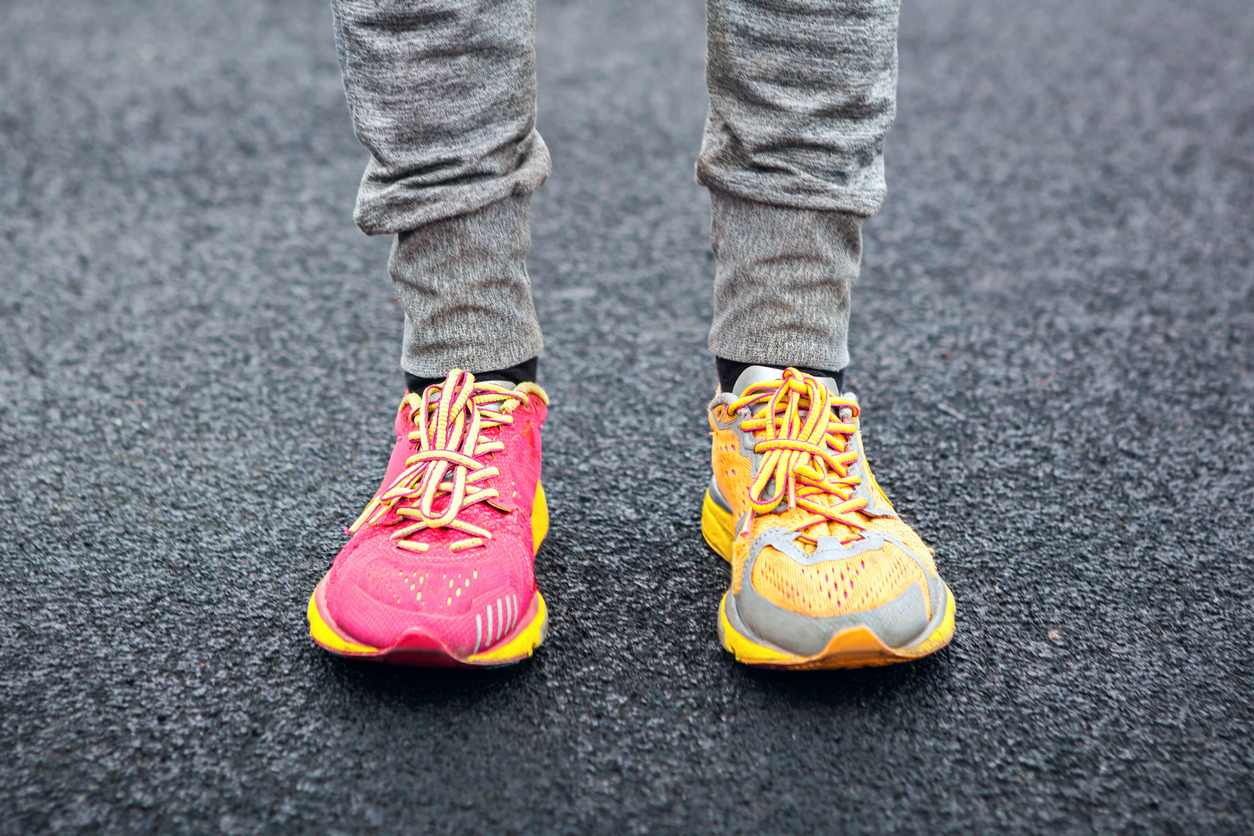 Legs in multi-colored running shoes.