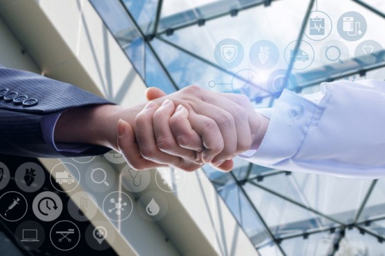 Businessman shaking hands with doctor.