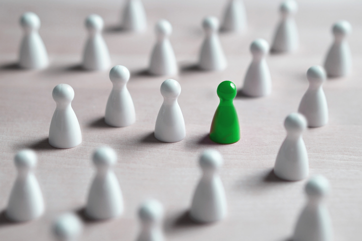 One different board game pawn. Individuality, independence, leadership and uniqueness concept. Stand out from the crowd. Think outside the box. Dare to be different.