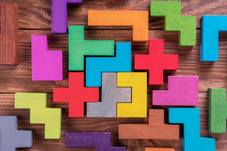 The concept of logical thinking. Geometric shapes on a wooden background.